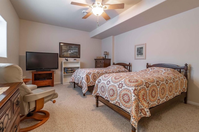 carpeted bedroom featuring baseboards and a ceiling fan