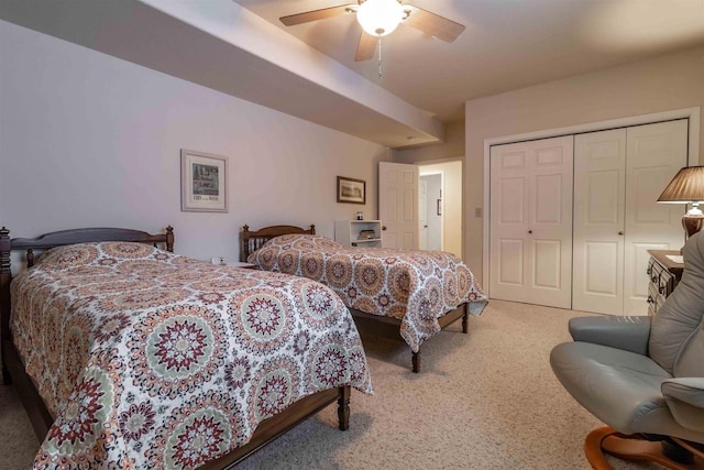 carpeted bedroom with a ceiling fan and a closet