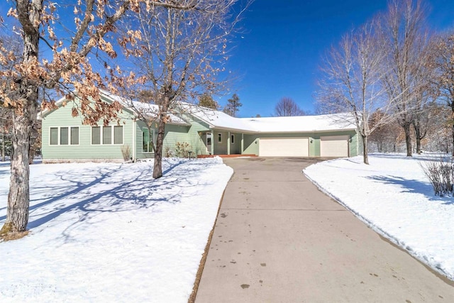 ranch-style home featuring a garage and driveway