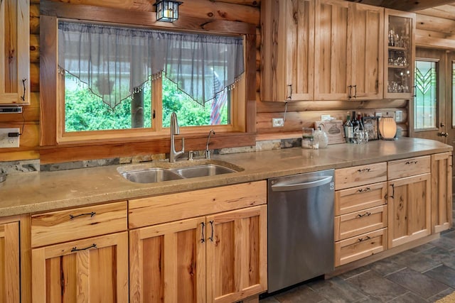 kitchen featuring a sink, light brown cabinets, light countertops, and stainless steel dishwasher