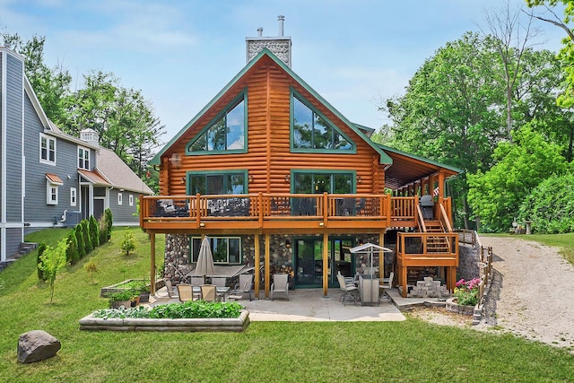 rear view of property with a chimney, a patio, log exterior, and a lawn