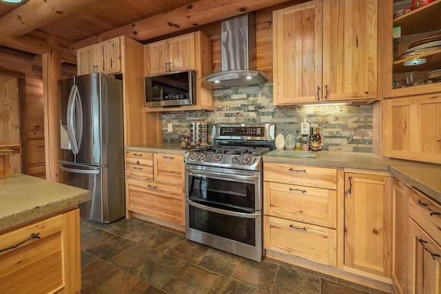 kitchen featuring wall chimney exhaust hood, light brown cabinets, stainless steel appliances, and decorative backsplash