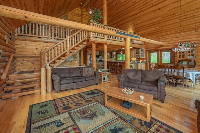 living area with high vaulted ceiling, wooden ceiling, wood-type flooring, and a notable chandelier