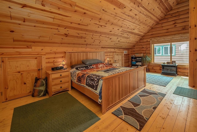 bedroom with wood ceiling, rustic walls, light wood-style flooring, and vaulted ceiling