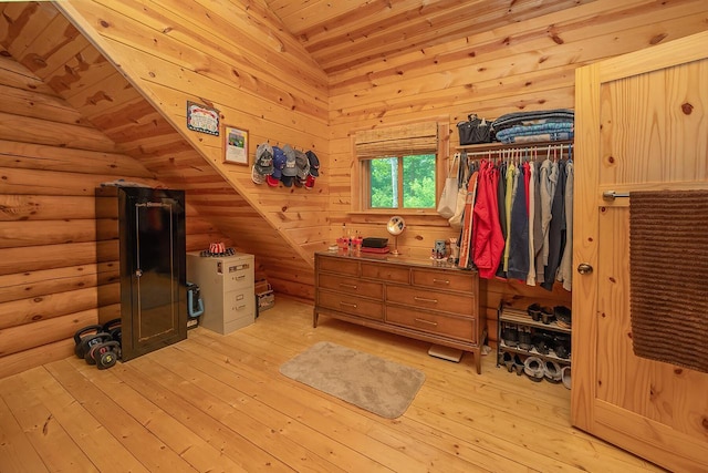 bedroom featuring vaulted ceiling, a closet, wood ceiling, and light wood-style floors