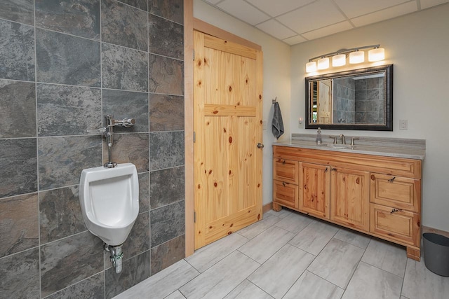 full bathroom with a drop ceiling and vanity