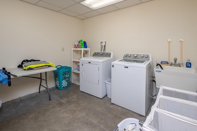 washroom with a sink, laundry area, and washer and dryer