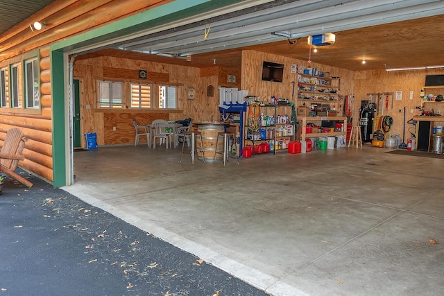 garage with a workshop area and a garage door opener