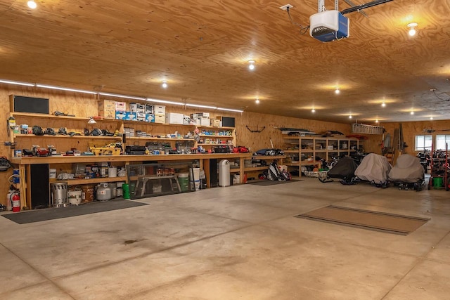 garage with a workshop area and a garage door opener