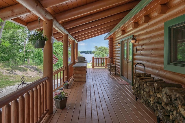 wooden deck featuring a water view