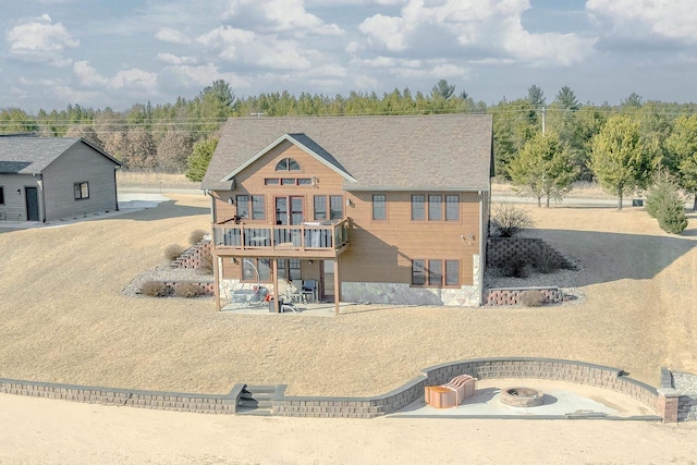 view of front facade with a patio and an outdoor fire pit