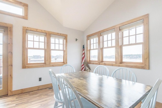 W5611 32nd St, New Lisbon, WI 53950 - dining area with light wood-type flooring, lofted ceiling, and baseboards