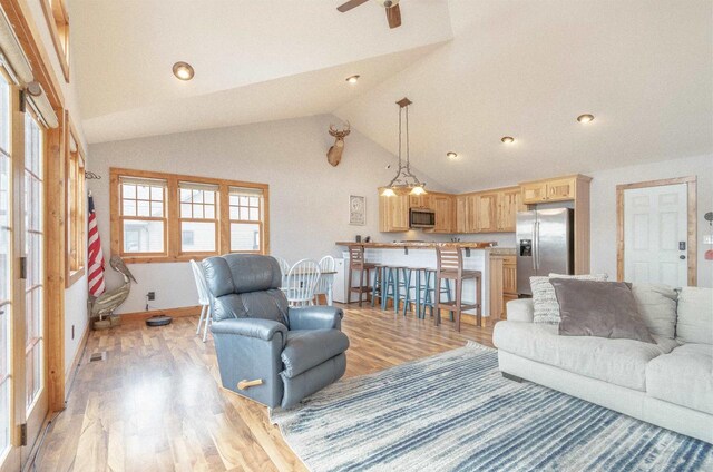 W5611 32nd St, New Lisbon, WI 53950 - living area with visible vents, light wood-style floors, ceiling fan, high vaulted ceiling, and baseboards