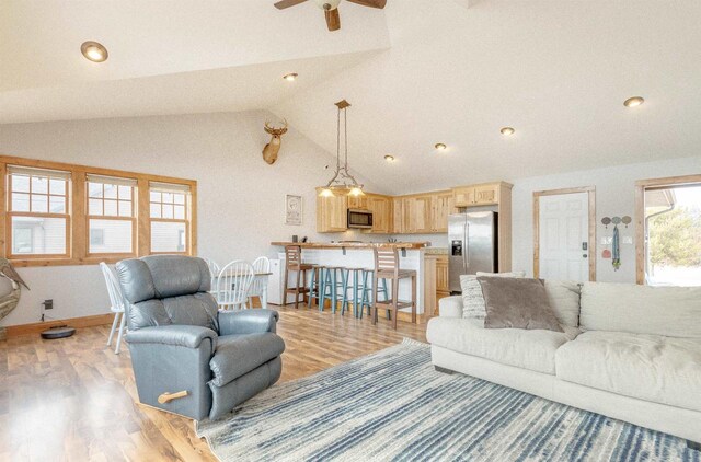W5611 32nd St, New Lisbon, WI 53950 - living area featuring vaulted ceiling, a ceiling fan, light wood-style flooring, and baseboards