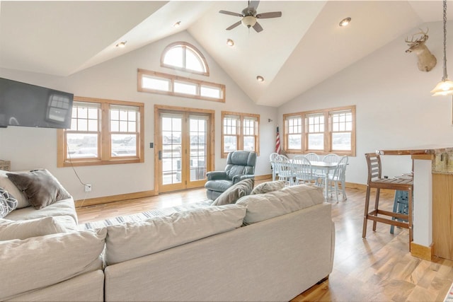 W5611 32nd St, New Lisbon, WI 53950 - living area featuring high vaulted ceiling, light wood-type flooring, a ceiling fan, and baseboards