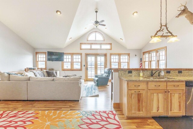 W5611 32nd St, New Lisbon, WI 53950 - kitchen with high vaulted ceiling, light wood-style flooring, a sink, a ceiling fan, and open floor plan