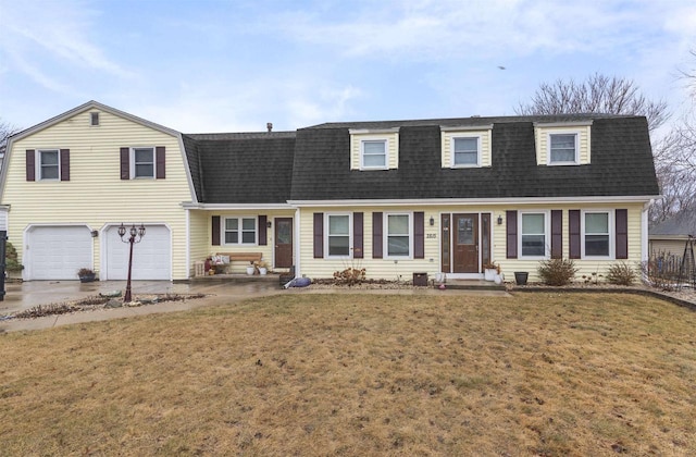 colonial inspired home with a front yard, roof with shingles, driveway, and a gambrel roof