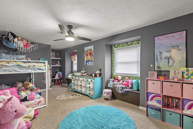 carpeted bedroom featuring ceiling fan and baseboards