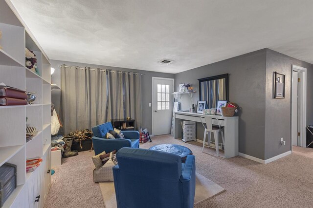 living room with baseboards, visible vents, and carpet flooring