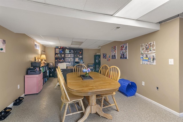 dining area featuring visible vents, baseboards, and a drop ceiling