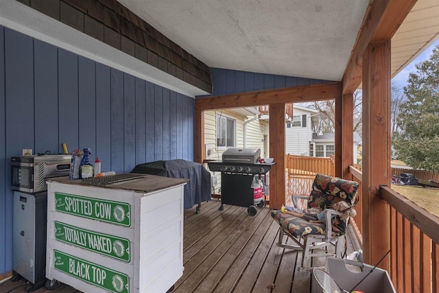 wooden terrace with a grill