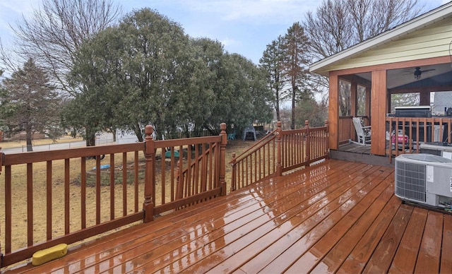 wooden deck featuring cooling unit and a sunroom