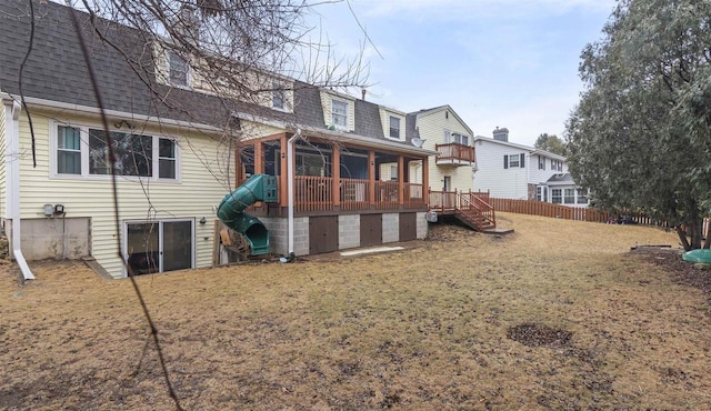 back of house featuring a shingled roof, fence, stairway, and a wooden deck