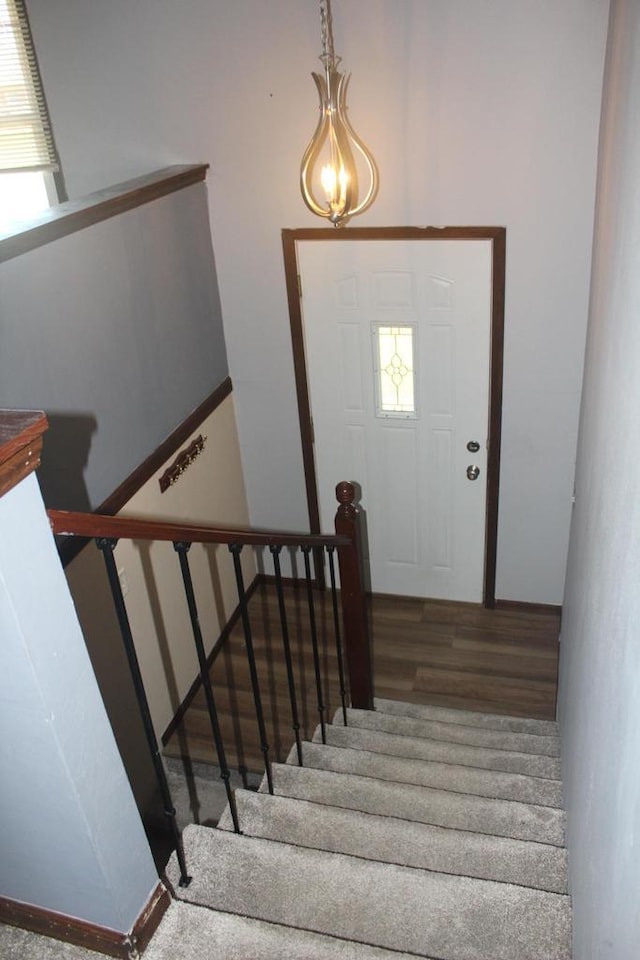 staircase with a wealth of natural light and wood finished floors