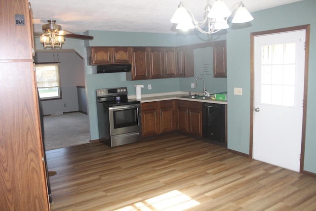 kitchen featuring stainless steel electric stove, light wood-style flooring, a sink, dishwasher, and under cabinet range hood