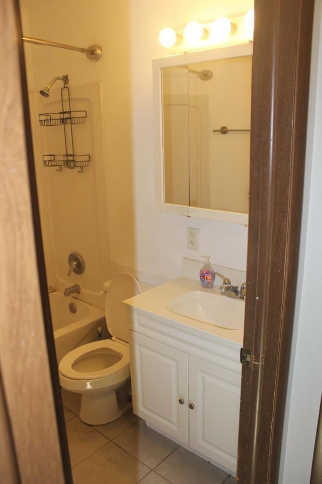 full bath with washtub / shower combination, tile patterned flooring, vanity, and toilet