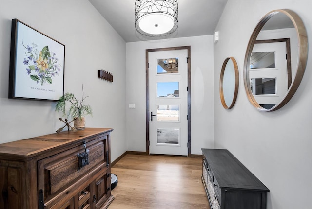 entryway with light wood-type flooring and baseboards