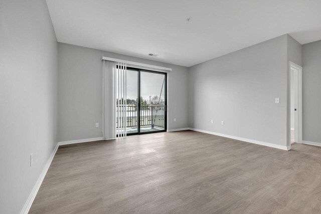 500 E Main St Unit 203, Waterford, WI 53185 - empty room featuring light wood-style floors, visible vents, and baseboards