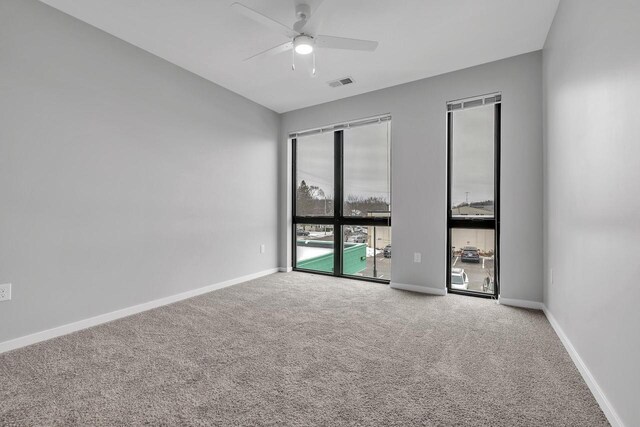 500 E Main St Unit 203, Waterford, WI 53185 - carpeted spare room with visible vents, ceiling fan, and baseboards