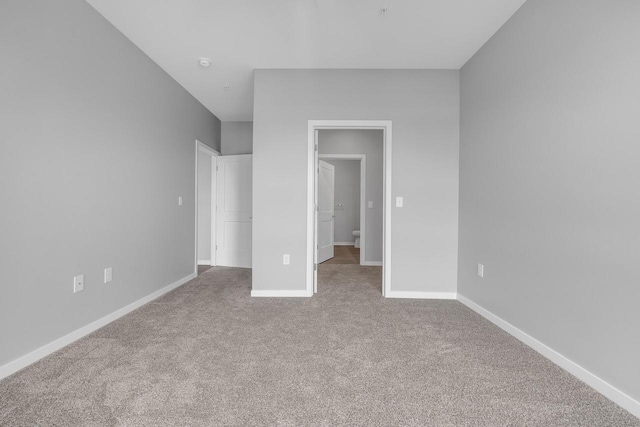 500 E Main St Unit 203, Waterford, WI 53185 - unfurnished bedroom featuring baseboards and carpet flooring