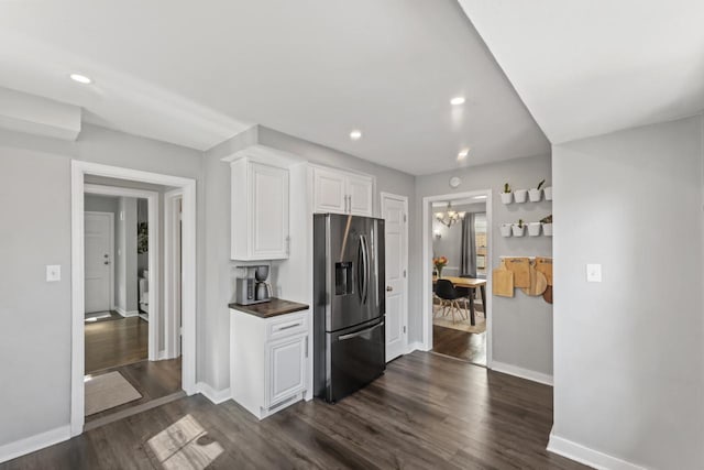 kitchen featuring white cabinetry, recessed lighting, stainless steel fridge, and dark wood-style flooring