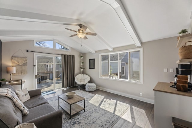 living area featuring lofted ceiling with beams, baseboards, wood finished floors, and ceiling fan