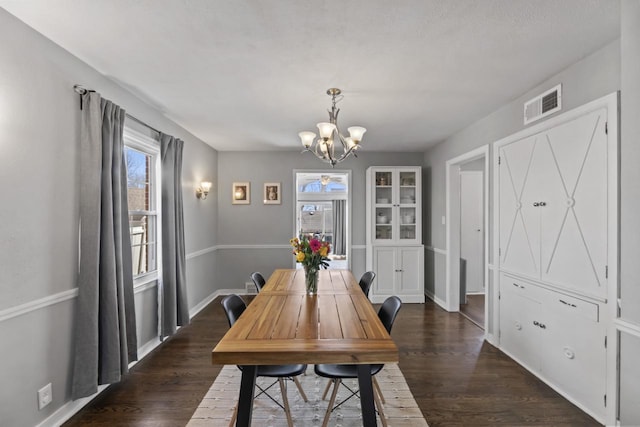 dining area featuring visible vents, plenty of natural light, and dark wood-type flooring