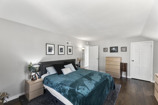 bedroom with visible vents, baseboards, and dark wood-type flooring