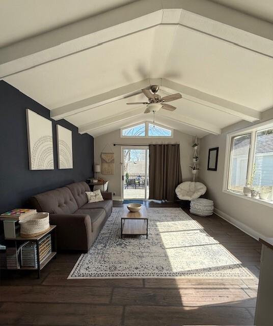 living area featuring dark wood finished floors, ceiling fan, vaulted ceiling with beams, and baseboards