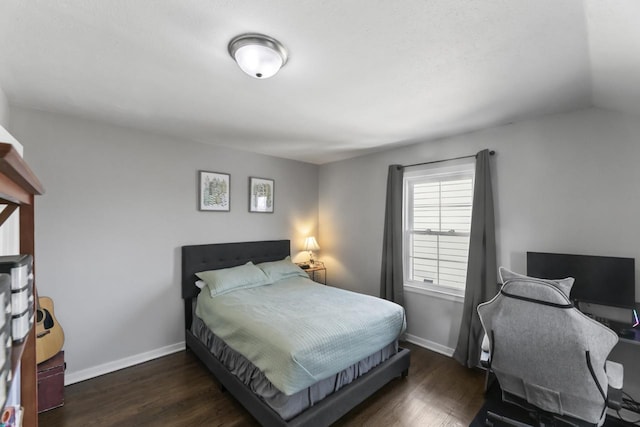 bedroom featuring baseboards and wood finished floors