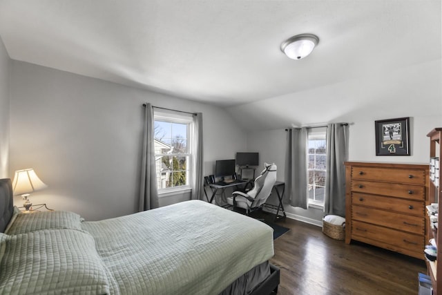 bedroom with baseboards, multiple windows, lofted ceiling, and dark wood-style flooring