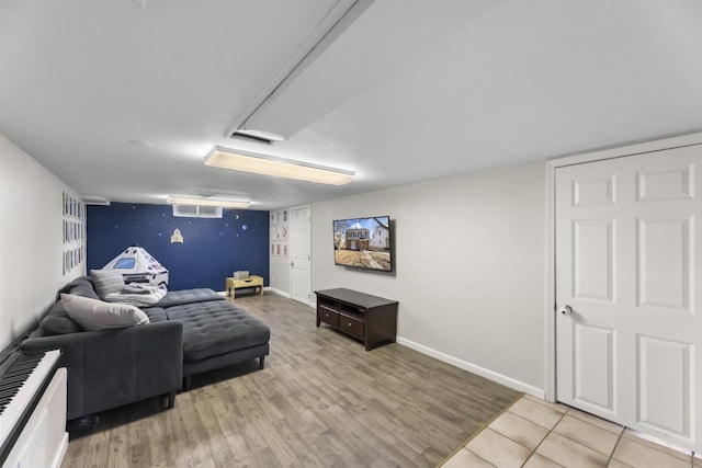 living area with visible vents, baseboards, and light wood-style flooring