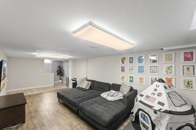 living area featuring baseboards and wood finished floors