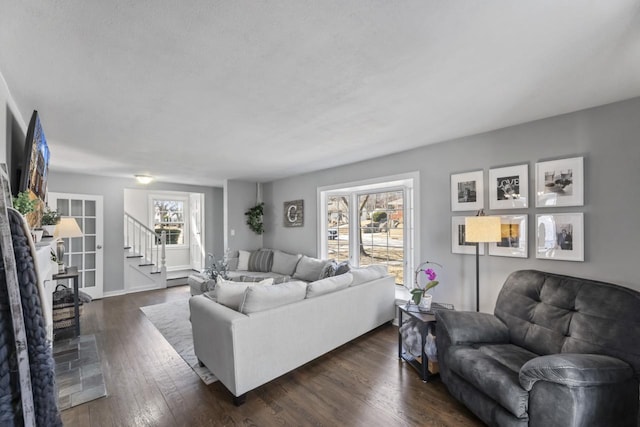 living room featuring stairway and dark wood-style floors