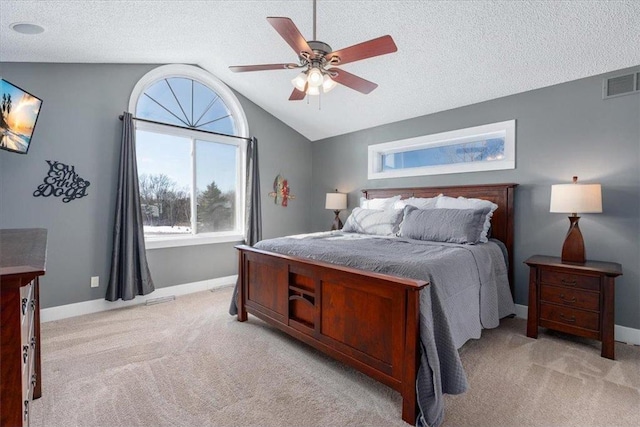 bedroom with baseboards, visible vents, light colored carpet, vaulted ceiling, and a textured ceiling