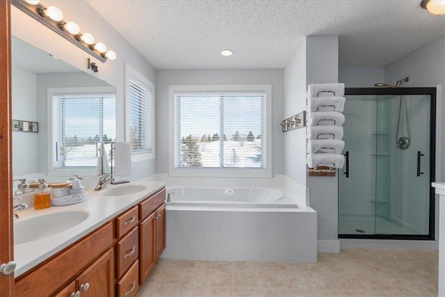 full bath featuring a garden tub, double vanity, a stall shower, and a sink