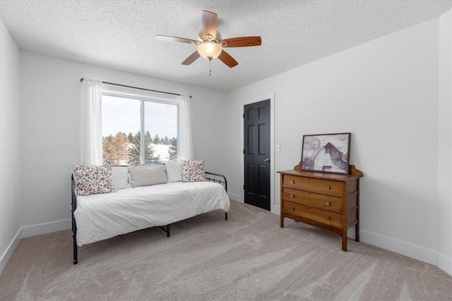 bedroom featuring a textured ceiling, carpet, a ceiling fan, and baseboards