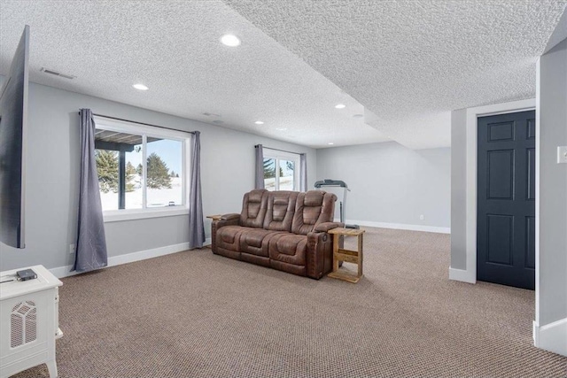 living room featuring visible vents, baseboards, a wealth of natural light, and light colored carpet