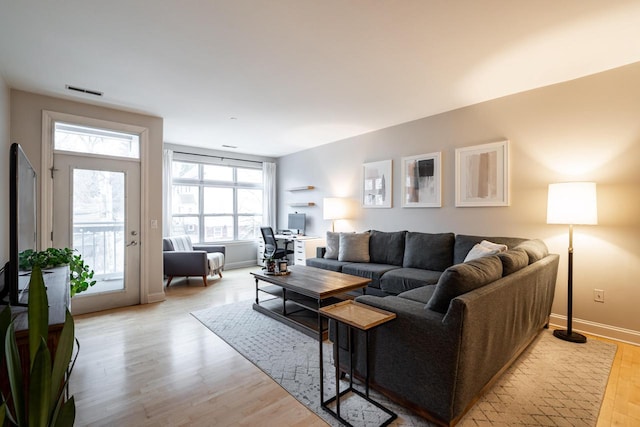 living room with light wood-style floors and baseboards