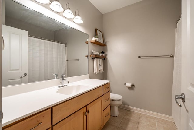 full bathroom featuring baseboards, vanity, toilet, and tile patterned floors